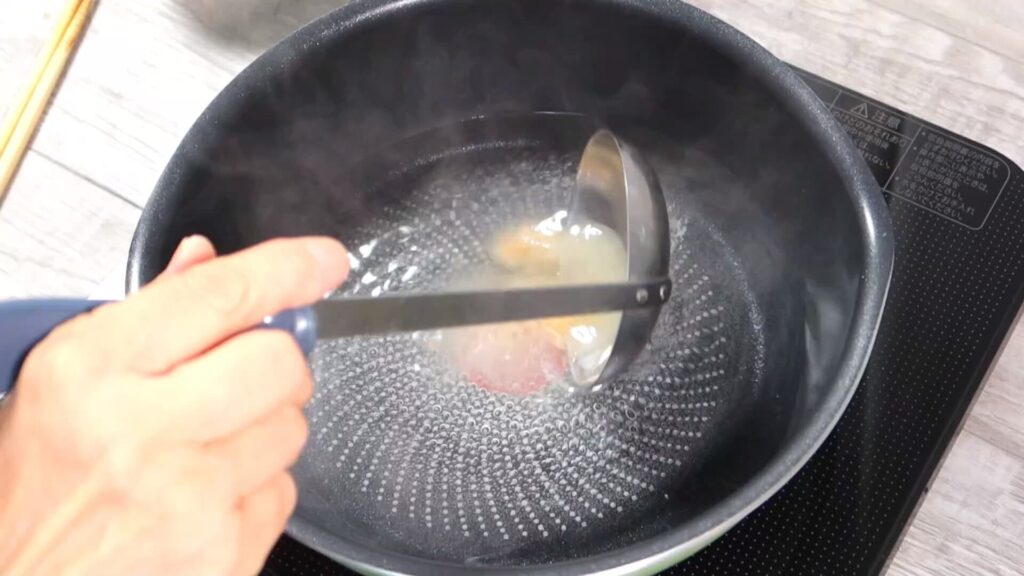 鍋にスープを入れている画像