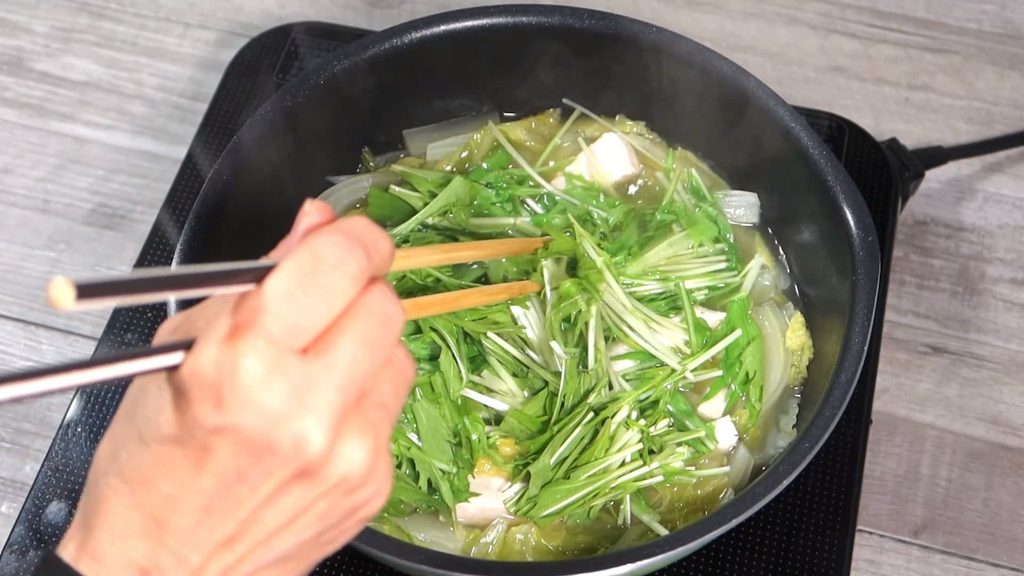 水菜を鍋に入れている画像